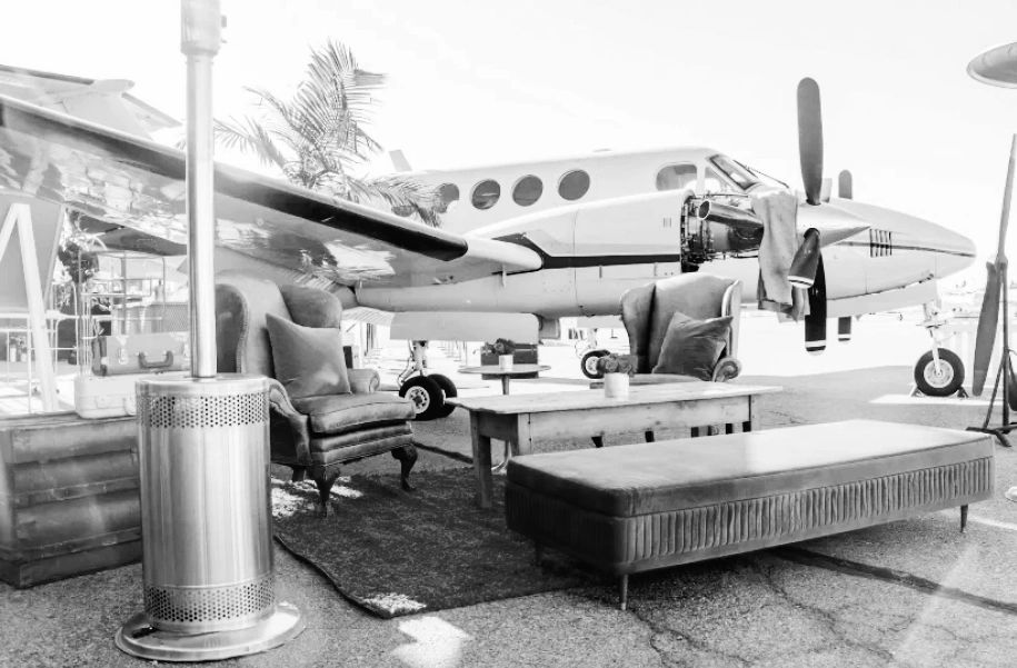 An aviation-themed event lounge beside an aircraft